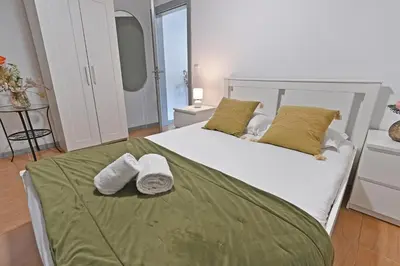 a bedroom with a bed with two towels on it at The Porto Way in Porto