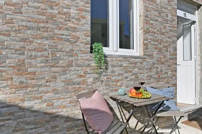 a table with a bowl of fruit next to a brick wall at The Porto Way in Porto