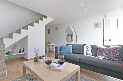 a living room with a couch and two glasses of wine at The Porto Way in Porto