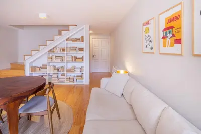 a living room with a white couch and a table at Almada 151 - 3T in Porto