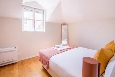 a bedroom with a large bed and a window at Almada 151 - 3T in Porto
