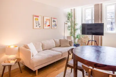 a living room with a couch and a table at Almada 151 - 3T in Porto