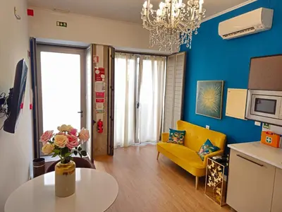 a living room with a yellow couch and a table at Serendipity in Porto