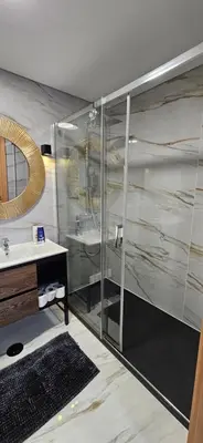 a bathroom with a shower with a sink and a mirror at Serendipity in Porto