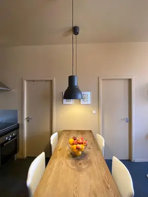 a dining room with a wooden table with a bowl of fruit at Sunny Apartment in Porto
