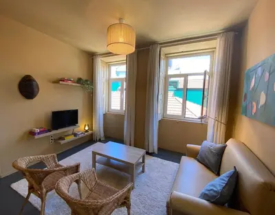 a living room with a couch and a table at Sunny Apartment in Porto