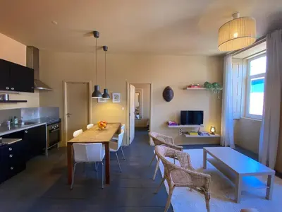 a kitchen and dining room with a table and chairs at Sunny Apartment in Porto