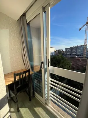 a balcony with a chair and a sliding glass door at Typical Oporto House in Porto