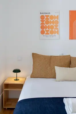 a bedroom with a bed and a nightstand with a bed sidx sidx at 58 House in Porto
