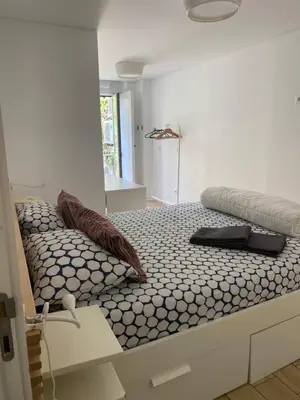 a bed with pillows on it in a room at Apartamento Formosa in Porto