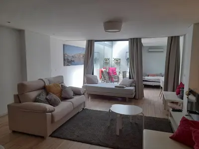 a living room with a couch and a table at Apartamento Formosa in Porto