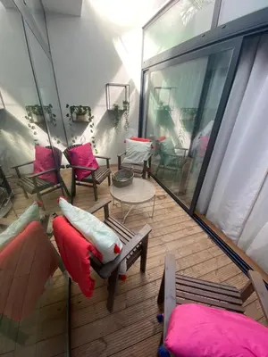 a balcony with chairs and tables and a room with windows at Apartamento Formosa in Porto