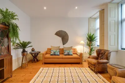 a living room with a couch and a chair at Cedofeita Vintage House DA'Home in Porto