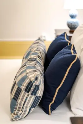 two pillows sitting on top of a bed at Cedofeita Vintage House DA'Home in Porto