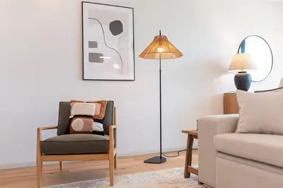 a living room with a chair and a lamp at Scenic River-View T1 by Lisbeyond in Vila Nova de Gaia