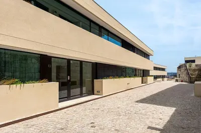 a building with large windows on the side of it at Scenic River-View T1 by Lisbeyond in Vila Nova de Gaia
