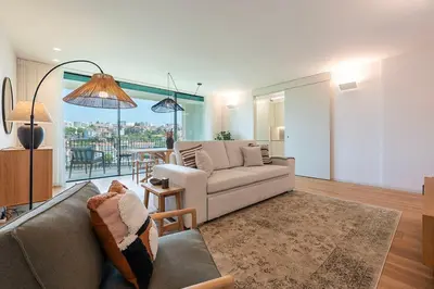 a living room with a couch and a table at Scenic River-View T1 by Lisbeyond in Vila Nova de Gaia