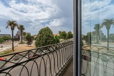 a balcony with a view of a street and palm trees at GuestReady - Explore Porto from a prime location in Porto