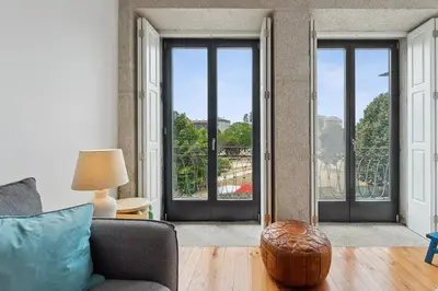 a living room with doors open to a balcony at GuestReady - Explore Porto from a prime location in Porto