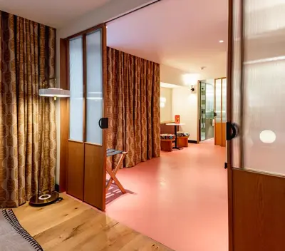 a bedroom with a large white bed and a table at Artcore Hotel Porto in Porto