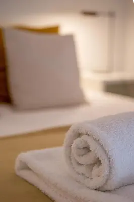 a roll of white towels sitting on a table at Almada 151 - 1T in Porto