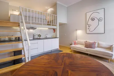 a living room with a staircase and a couch in a room at Almada 151 - 1T in Porto