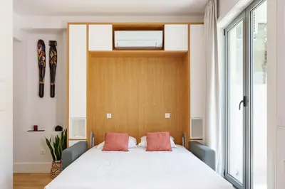a bedroom with a large white bed with two pillows at VIVA João IV Residence Studios in Porto
