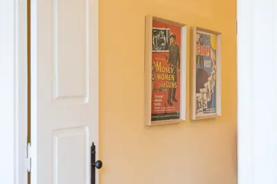 three posters on a wall next to a door at GuestReady - Vereda Downtown Apartments in Porto