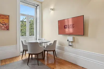 a dining room with a table and chairs and a window at GuestReady - Vereda Downtown Apartments in Porto