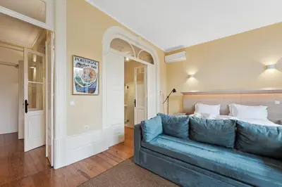 a living room with a blue couch in a room at GuestReady - Vereda Downtown Apartments in Porto