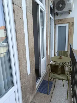 a table and a chair on a balcony at Porto Alma 388 - Silent city center in Porto