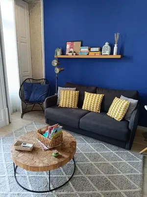 a living room with a black couch and a table at Porto Alma 388 - Silent city center in Porto
