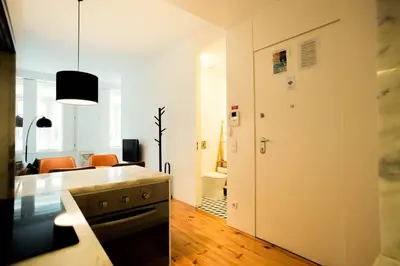 a room with a kitchen and a living room at PortoCenter METRO Marquis Cozy apartment in Porto