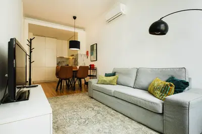 a living room with a couch and a television at PortoCenter METRO Marquis Cozy apartment in Porto