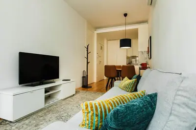a living room with a couch and a flat screen tv at PortoCenter METRO Marquis Cozy apartment in Porto