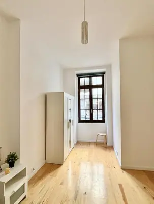 an empty room with a refrigerator and a window at Porto Boavista Patio House in Porto
