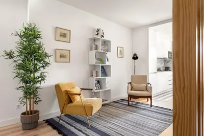 a living room with two chairs and a plant at GuestReady - Fantastic Porto Flat in Porto