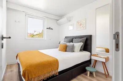 a bedroom with a bed with a yellow blanket on it at GuestReady - Fantastic Porto Flat in Porto