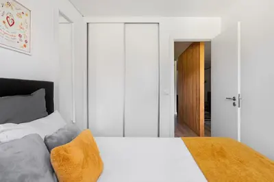 a bedroom with a white bed and a sliding door at GuestReady - Fantastic Porto Flat in Porto