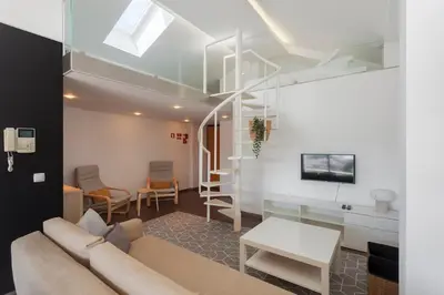 a living room with a couch and a table at Rosario Duplex in Porto