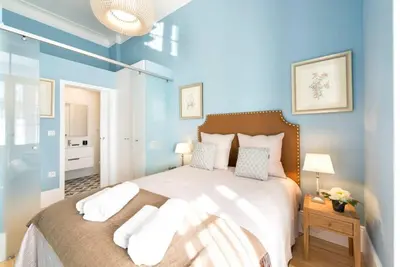 a bedroom with a large bed with blue walls at Wine Cellar by Upperground in Porto