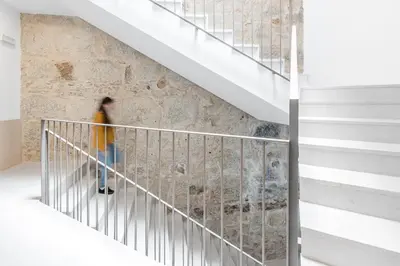 a person walking down the stairs of a house at Modern Invicta by Upperground in Porto