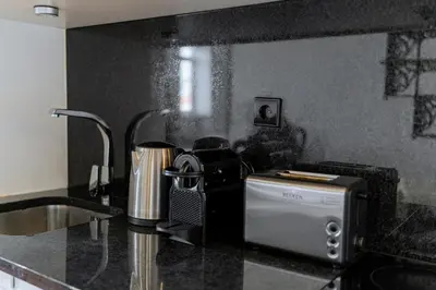 a kitchen with a counter top with a toaster and a sink at Cozy Stay w/ AC and View in Porto