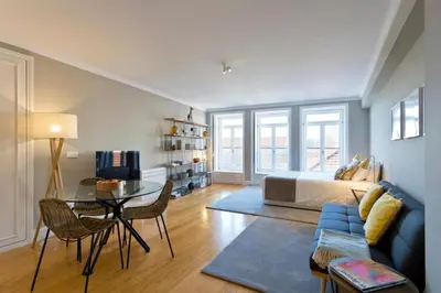 a living room with a bed and a glass table at Historical Corner by Upperground in Porto