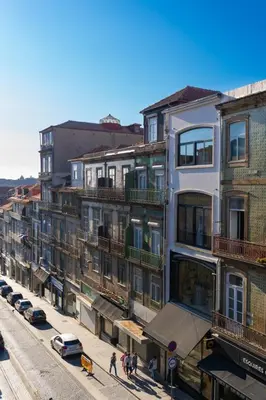 a tall white building with balconies on a city street at Heart of Porto by Upperground in Porto