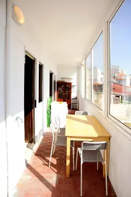 a dining room with a wooden table and chairs at Baron Omega in Porto