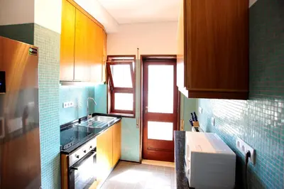 a small kitchen with a sink and a stove at Baron Omega in Porto