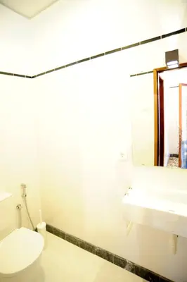 a bathroom with a toilet and a sink at Omega White in Porto