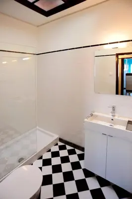 a bathroom with a toilet and a sink and a mirror at Omega White in Porto