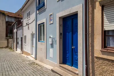 a blue door on a building on a street at Bom Retiro's Delight by LovelyStay in Porto